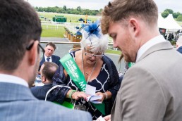 volunteer collecting money at York Races for Macmillan