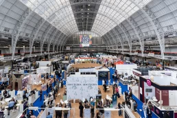 Wide audience shot during a stage launch at London Wine Fair 2026, Kensington Olympia, photographed by Nate.