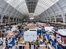 Wide audience shot during a stage launch at London Wine Fair 2026, Kensington Olympia, photographed by Nate.