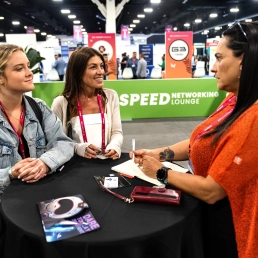 Attendees engaged in conversation at the speed networking lounge at SBC Summit Americas gaming industry conference