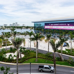 Exterior of the SBC Summit Americas conference and exhibition centre in Fort Lauderdale with palm trees in the foreground